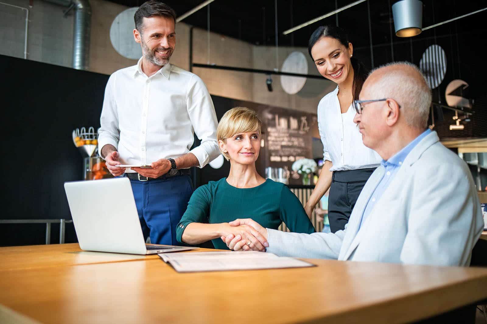 Group of business people signing a contract with handshake Blog posts